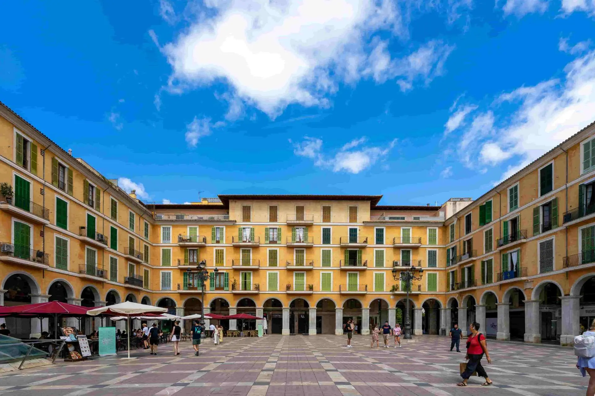 Spanish plaza with cafes and pedestrians – public liability insurance for businesses