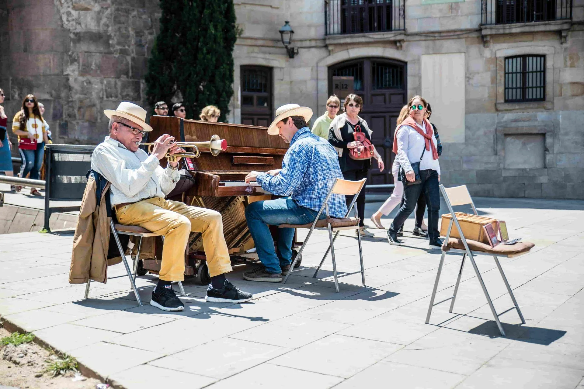 Street musicians in Spanish plaza - annual travel insurance for expats living in Spain